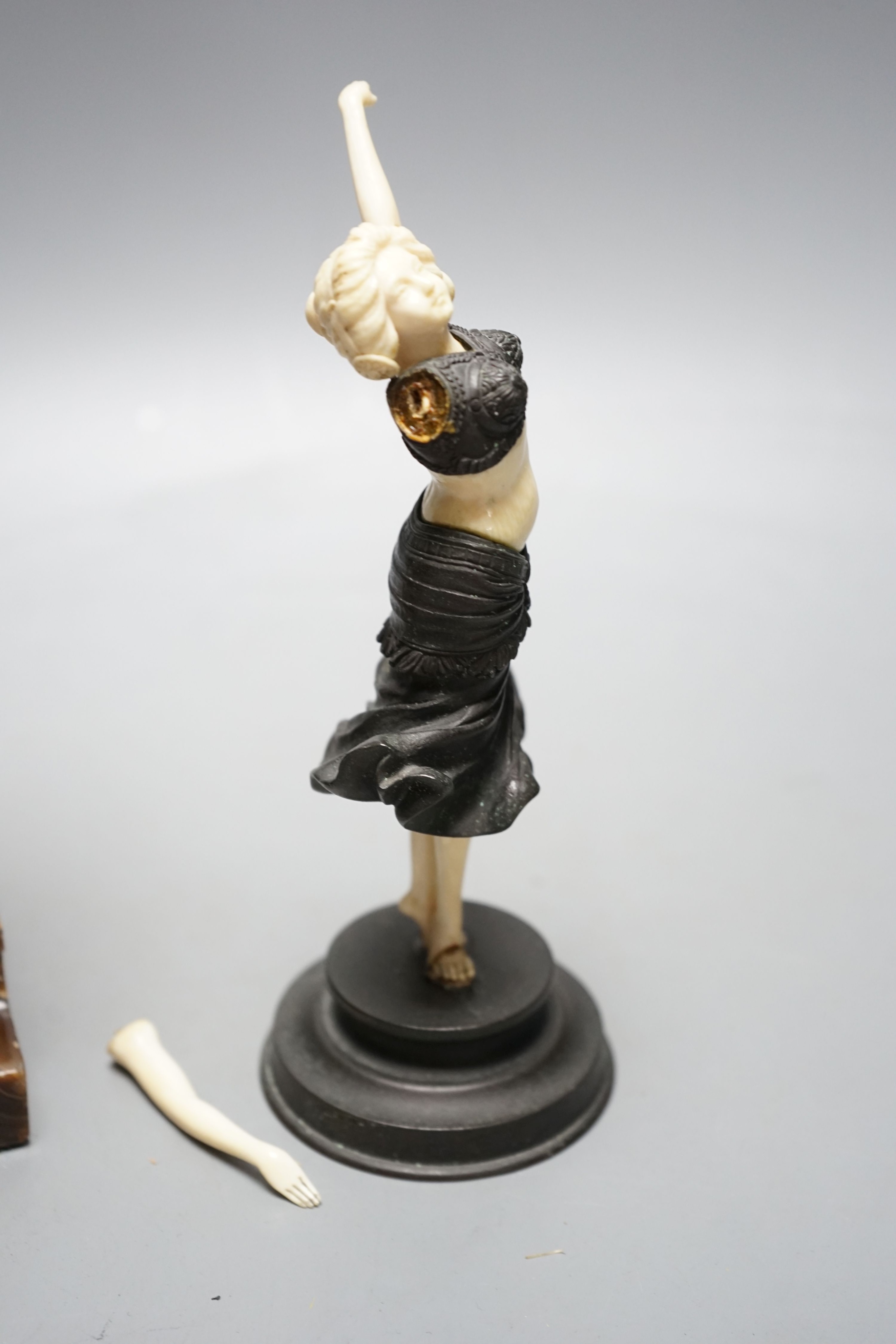Georges Van Der Straeten, Belgian 1856-1928, An Art Deco bronze and ivory figure of a girl reading a book together with a smaller bronze and ivory figure, Tallest 31.5 cms high.